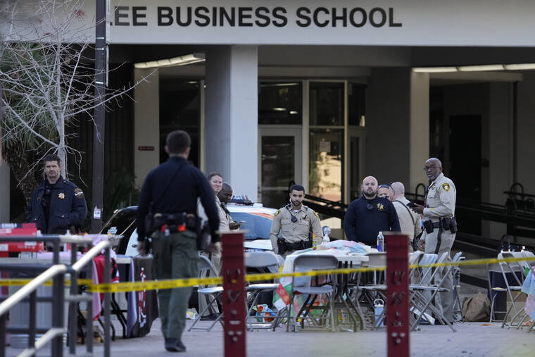 ASSOCIATED PRESS
                                Las Vegas police stand near the scene of a shooting at the University of Nevada, Las Vegas, Thursday, in Las Vegas. Terrified students and professors cowered in classrooms and dorms as a gunman roamed the floors of a campus building on Wednesday, killing several people and critically wounding another person before dying in a shootout with police.