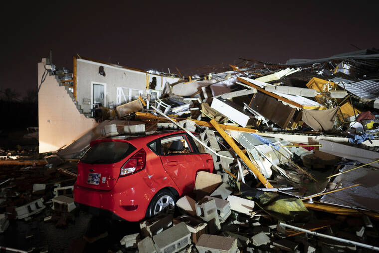 ANDREW NELLES/THE TENNESSEAN VIA AP / DEC. 9
                                A car is buried under rubble on Main Street after a tornado hit Hendersonville, Tenn.