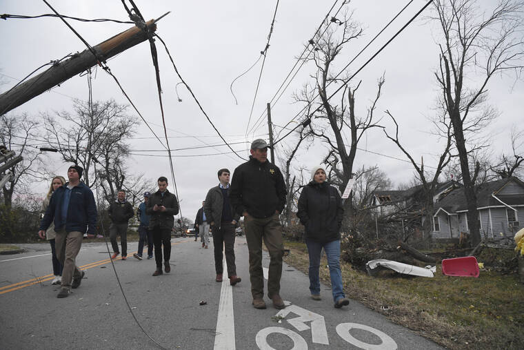 NICOLE HESTER/THE TENNESSEAN VIA ASSOCIATED PRESS
                                Gov. Bill Lee and first lady Maria Lee, right, walk through the streets ahead of a news conference in Madison, Tenn., Sunday, following deadly tornadoes and severe weather over the weekend.