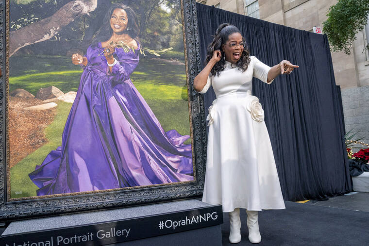 JACQUELYN MARTIN/AP
                                Oprah Winfrey shouts out to a member of the crowd while next to her portrait during a portrait unveiling ceremony at the Smithsonian’s National Portrait Gallery in Washington.