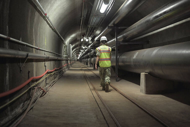 U.S. NAVY
                                Fuels director Lt. Cmdr. Shannon Bencs walks a portion of the seven miles of tunnels of the Red Hill Underground Fuel Storage Facility.