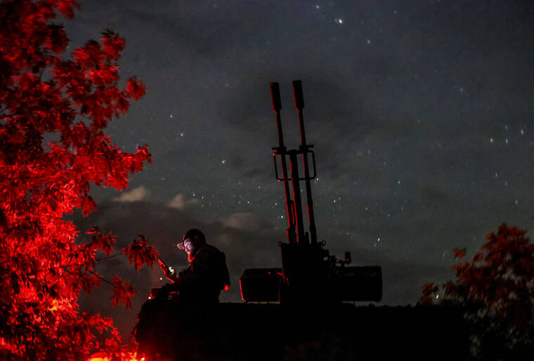 REUTERS/IVAN ANTYPENKO / JUNE 11
                                A Ukrainian serviceman from an anti-drone mobile air defence unit uses his mobile device near a ZU-23-2 anti aircraft cannon as he waits for Russian kamikaze drones, amid Russia’s attack on Ukraine, in Kherson region, Ukraine.