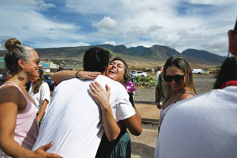 ANDREW VLIET / SPECIAL TO THE STAR-ADVERTISER
                                Ariel Ah Hee hugs guest following the blessing of their rebuilt home in Lahaina on Friday.