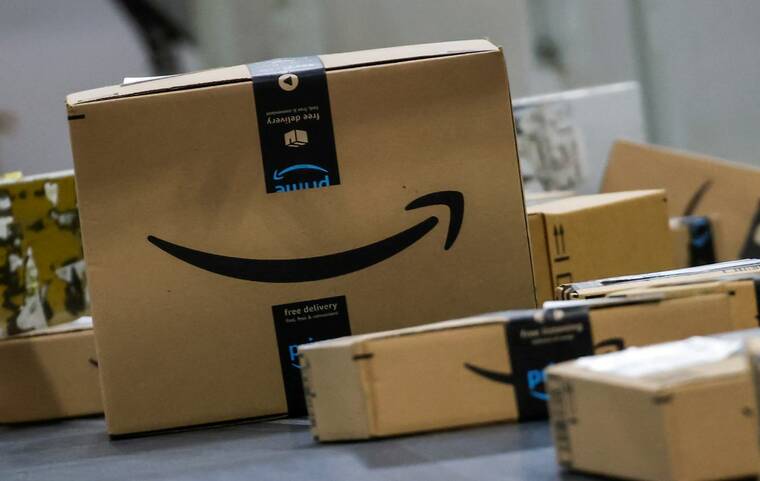 REUTERS/EDUARDO MUNOZ/FILE PHOTO
                                Boxes lie on a conveyor belt during Cyber Monday at Amazon’s fulfillment center in Robbinsville, N.J., on Dec. 2. Pressure is building on Amazon.com to come to the bargaining table with the Teamsters union as thousands of workers threaten to strike during the retailer’s busy holiday selling season.