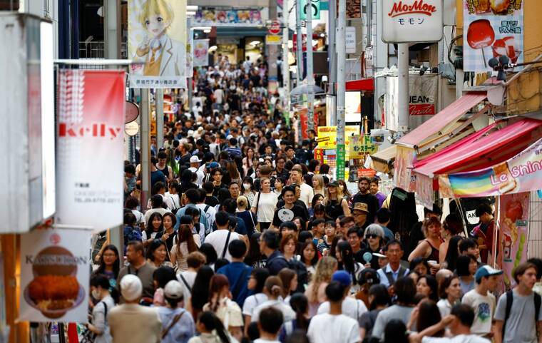 REUTERS/WILLY KURNIAWAN/FILE PHOTO
                                People walk along Takeshita Street at Harajuku shopping area in Tokyo, Japan, on Aug. 10. Japan set a new annual record for visitor arrivals with one month to spare, official data showed on Wednesday, as the weak yen helped propel the nation’s tourism boom.