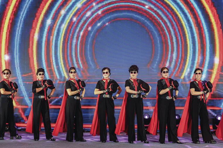 NEW YORK TIMES 
                                Above, a group of older women performs during a fall festival at a mall in Jinan, in eastern China.