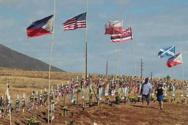 GEORGE F. LEE / GLEE@STARADVERTISER.COM
                                A Philippine flag flies in the foreground over a memorial of crosses that were erected and dedicated to victims of the Maui wildfires.