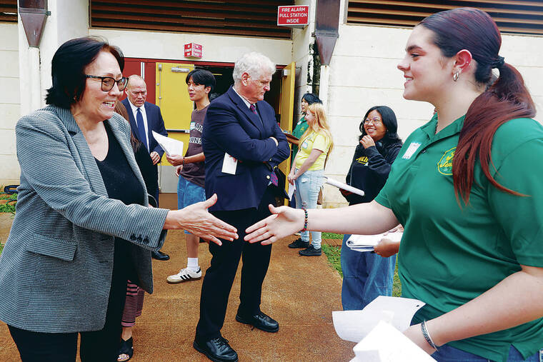 GEORGE F. LEE / GLEE@STARADVERTISER.COM
                                Above, Justices Sabrina S. MeKenna, left, Vladimir P. Devens and Mark Recktenwald were greeted by high school students and participated in a post-proceeding interview.