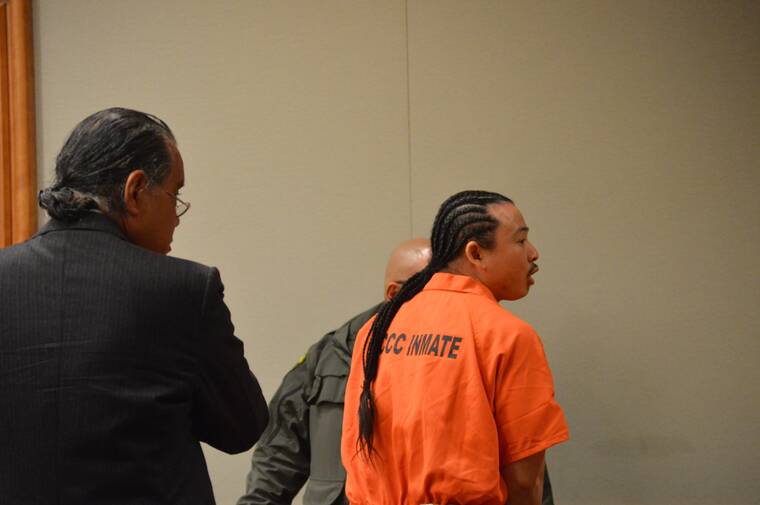 JOHN BURNETT/TRIBUNE-HERALD
                                Jarvis Boots turns to speak to a loved one in the gallery Friday in Hilo Circuit Court. Looking on is Boots’ court-appointed attorney, Stanton Oshiro.