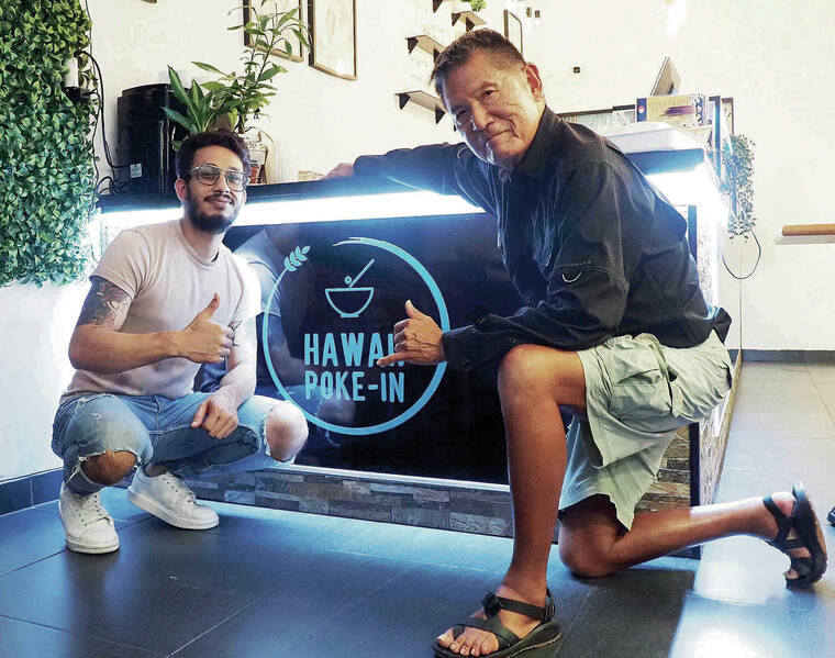 Makiki resident Ron Paik, right, and the owner of Hawaii Poke-In, got together for a quick picture. Paik was in the Principe Real neighborhood of Lisbon, Portugal, where he discovered the tasty reminder of home. Photo by a restaurant assistant.