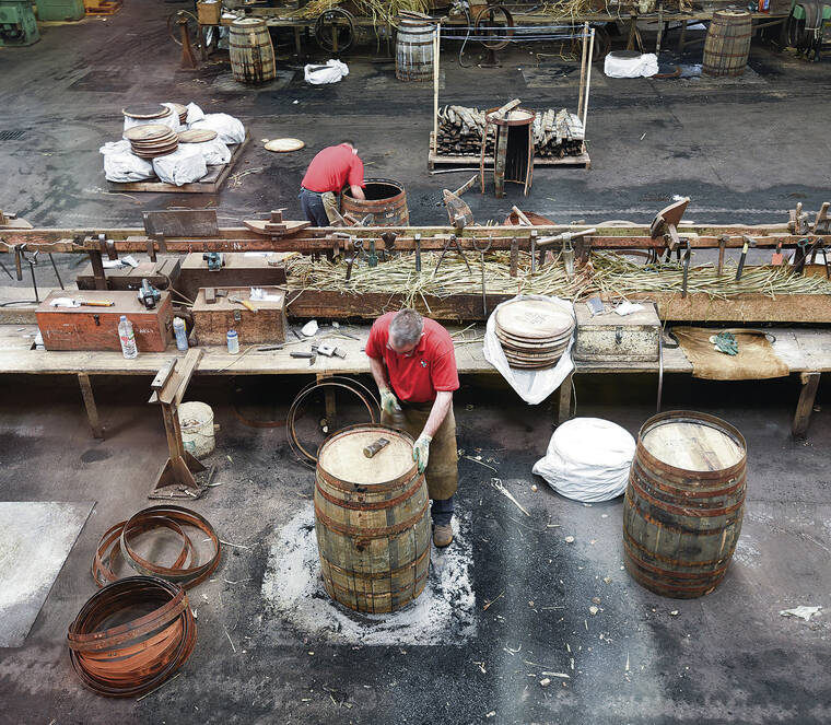 COURTESY CAMERON HEWITT
                                Workers at Scotland’s Speyside Cooperage fashion oak casks for aging Scotch whisky.